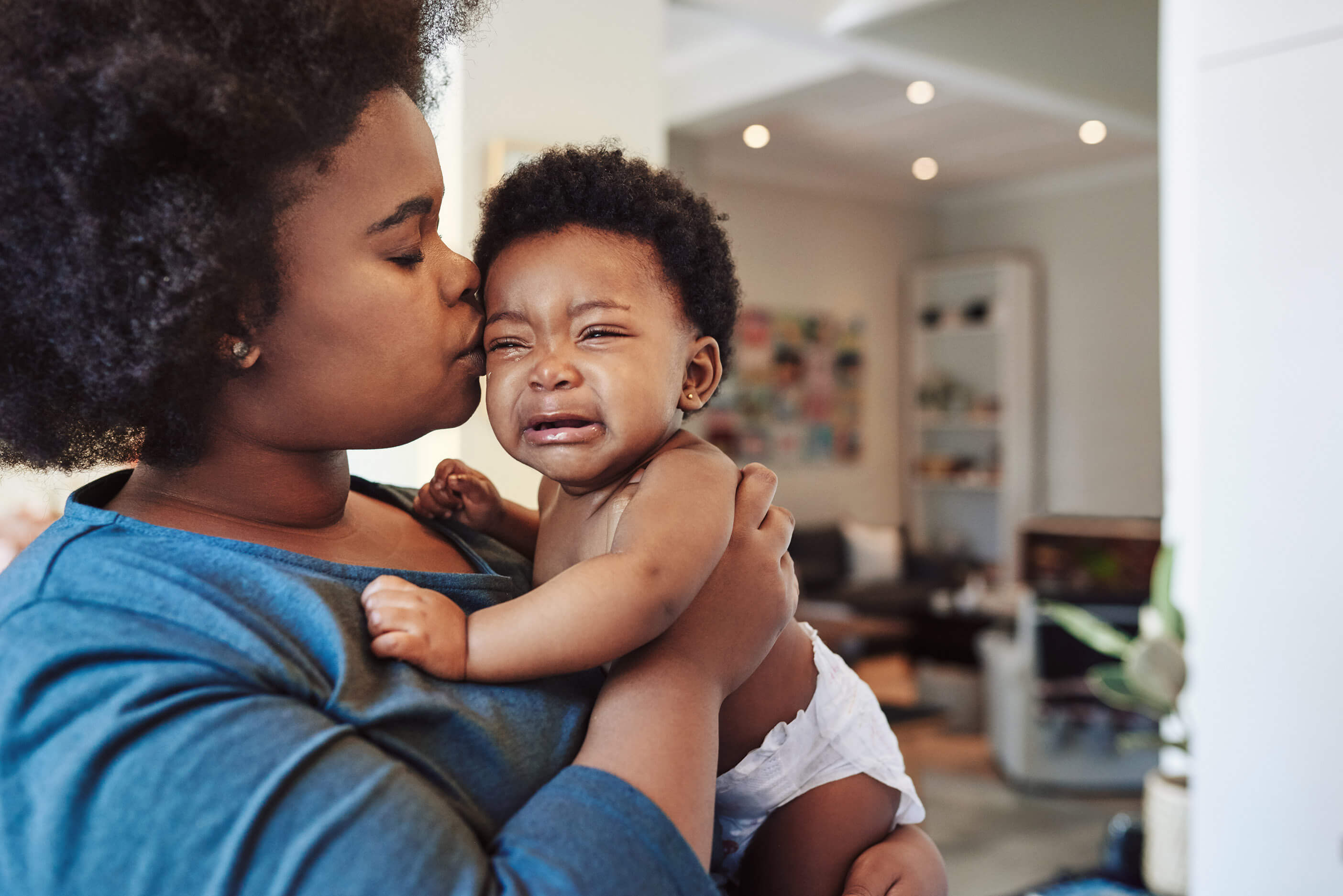 A mother holding her crying child