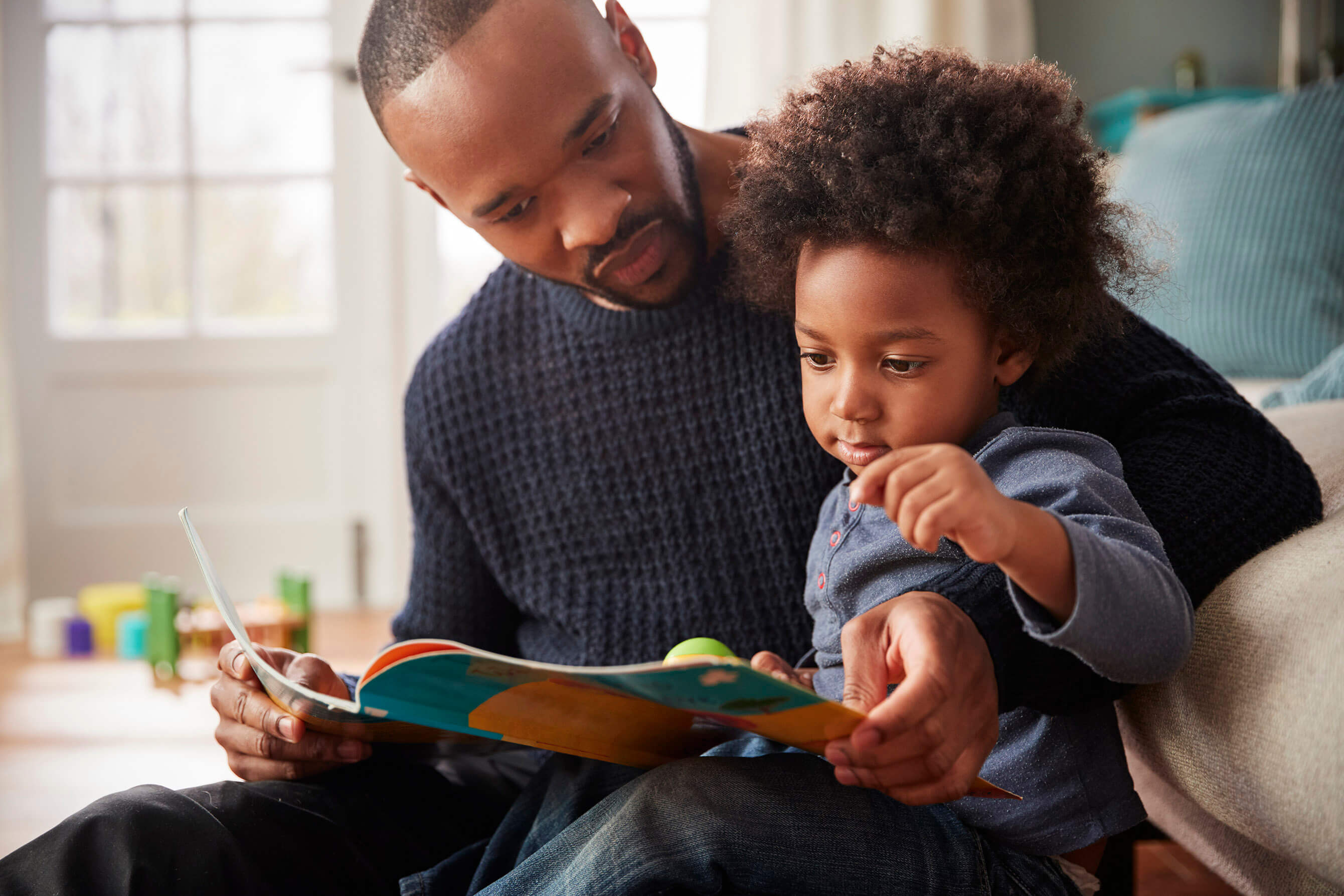 A man reading to his child 